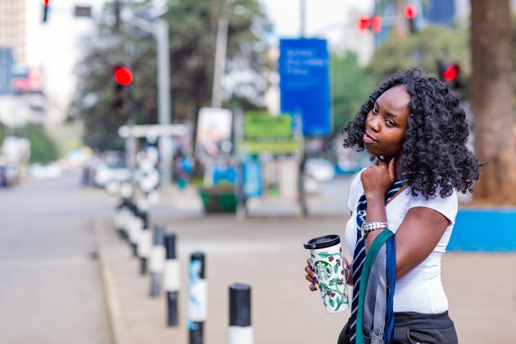 Woman Holding A Coffee Cup On A Street