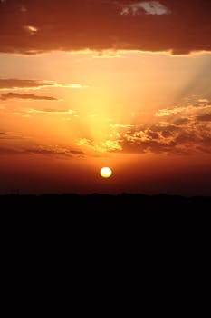 Stunning sunset over Timokten, Algeria with vibrant colors and dramatic clouds.