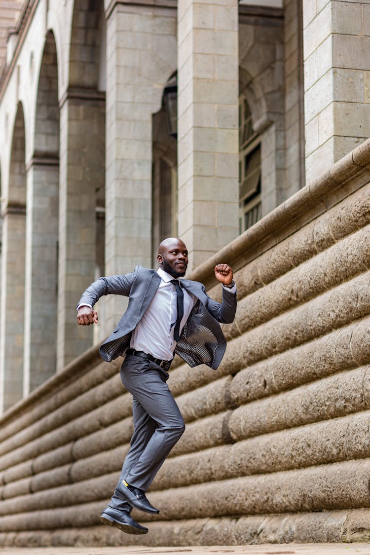 A Man In A Suit Jumping