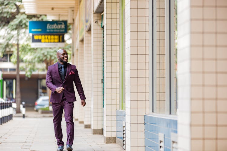 Man Wearing Suit Smiling While Walking