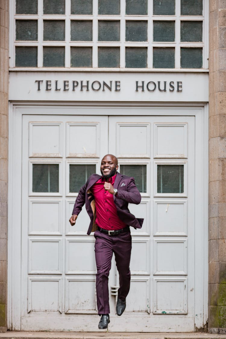 Man In Suit Running From Telephone House Door