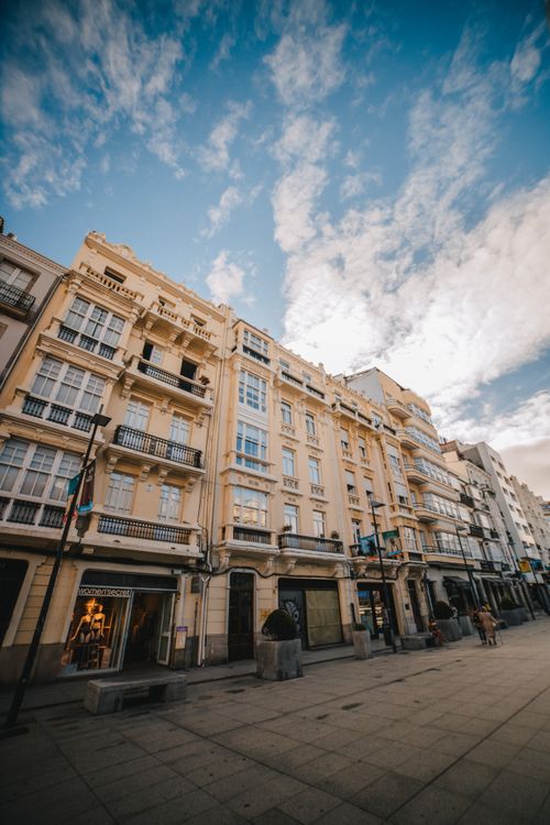 Free Low-angle view of historic European buildings with a cloudy sky, showcasing urban charm. Stock Photo