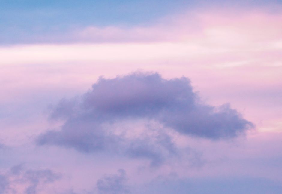 Beautiful skyscape featuring soft pink and blue clouds at twilight, creating a serene and peaceful atmosphere.