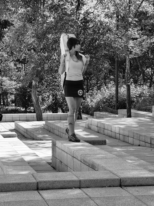 A Woman Standing on the Concrete Bench