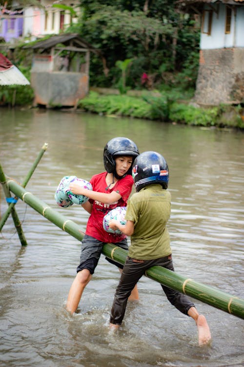 Kids Having a Pillow Fight while Sitting on Bamboo 