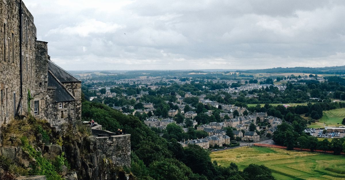Stone Buildings on Cliff Side Overlooking Valley · Free Stock Photo