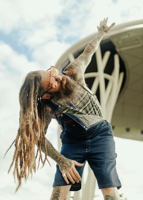 Free Mature man with dreadlocks and tattoos posing outdoors in Des Moines, IA. Stock Photo