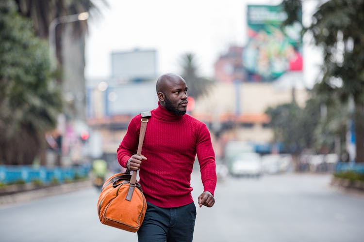 A Man Walking With A Bag