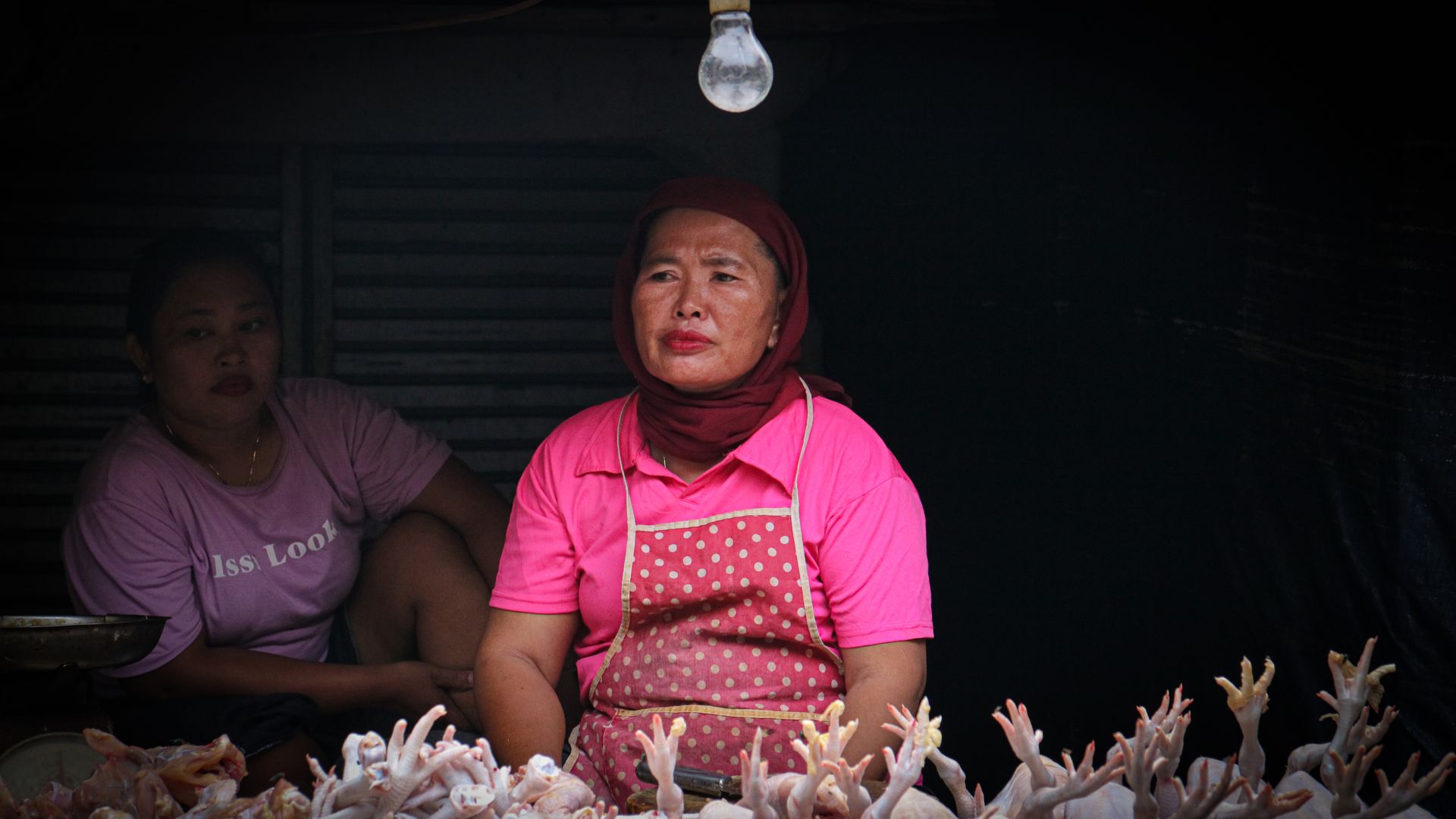 A Woman Selling Raw Chicken in the Market