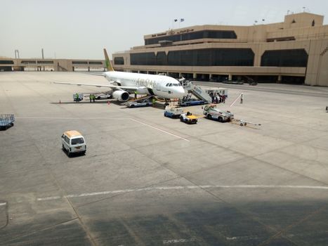 Airline jet preparing for takeoff on a sunny day at Karachi Airport.