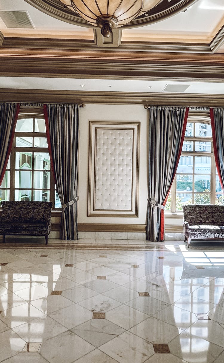 Hotel Hall With Marble Tiled Floor And Gray Curtains