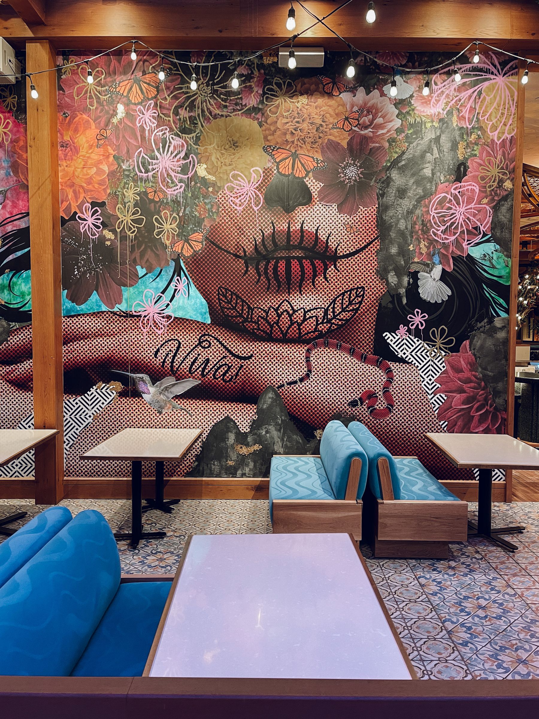 Colorful mural installed across a contemporary restaurant interior