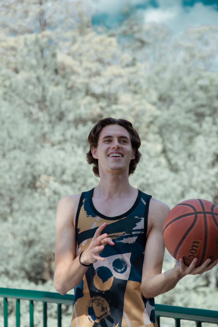 Man Holding A Basketball Wearing Sport Shirt