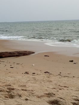 A tranquil sandy beach with gentle waves and a serene horizon, perfect for relaxation.