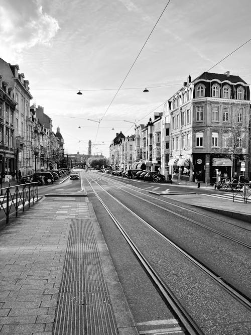 Black and White Photo of a City Street with Tramways in Perspective