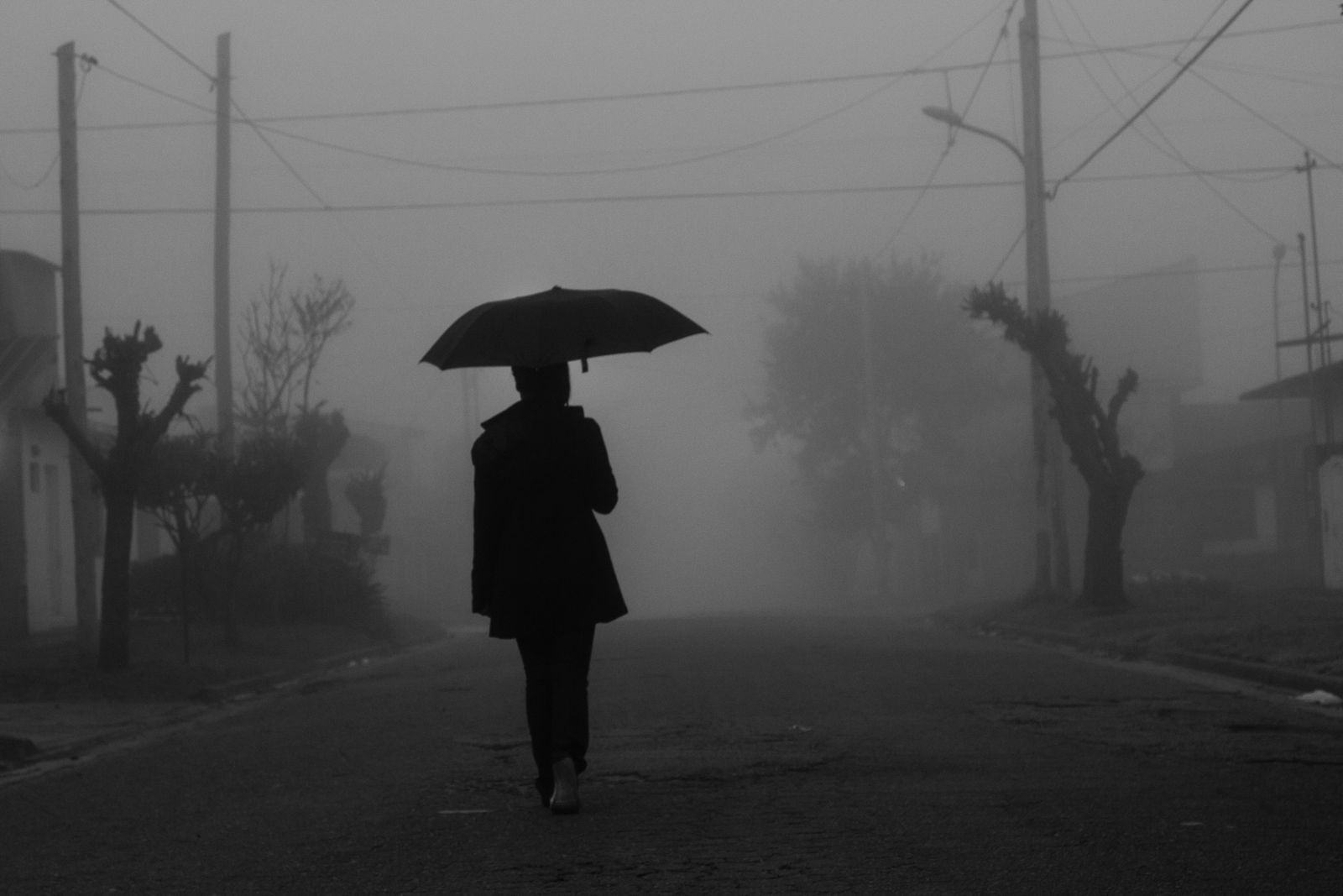 Models walking through heavy rain at night — photo by Sergio Geller on Pexels