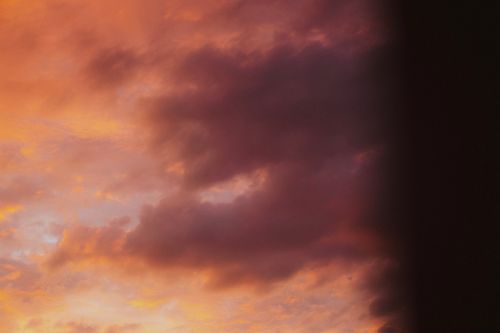 Free A captivating twilight sky with vibrant orange and pink clouds creating a serene atmosphere. Stock Photo