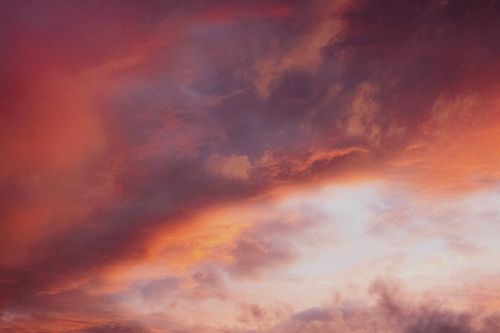 Free A breathtaking view of a dramatic sunset sky with vivid colors and clouds. Stock Photo