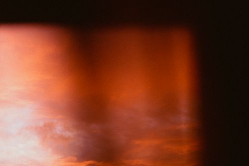 Free Atmospheric blurred sunset sky with rich orange tones, creating a dramatic and dreamy effect. Stock Photo