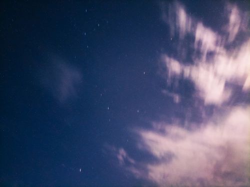 Free A serene starry night sky over Mostaganem, Algeria with beautiful cloud formations. Stock Photo