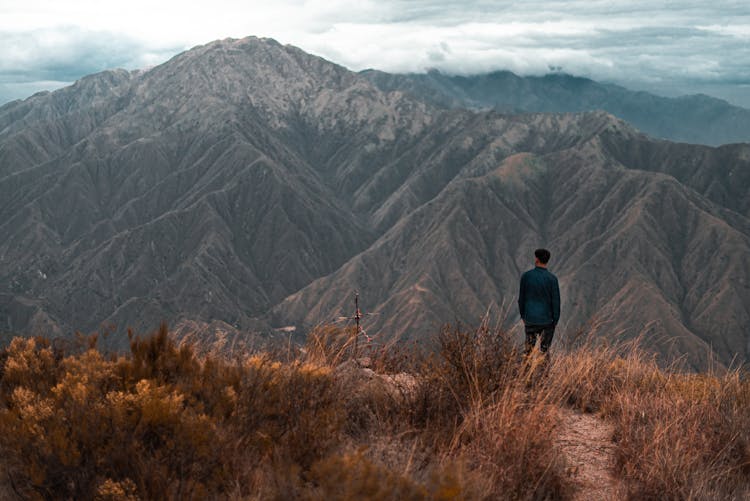 Man Standing On Mountain Top