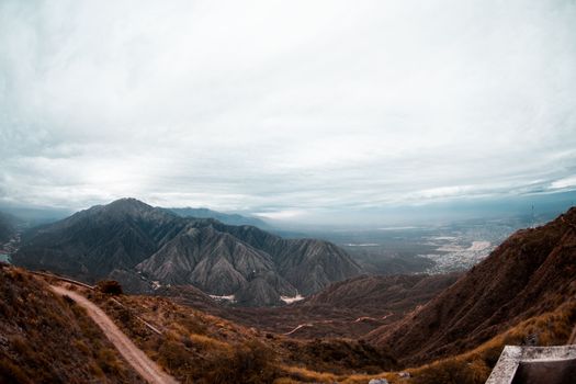 A scenic aerial view of La Rioja's rugged mountains under a cloudy sky, capturing the region's natural beauty.