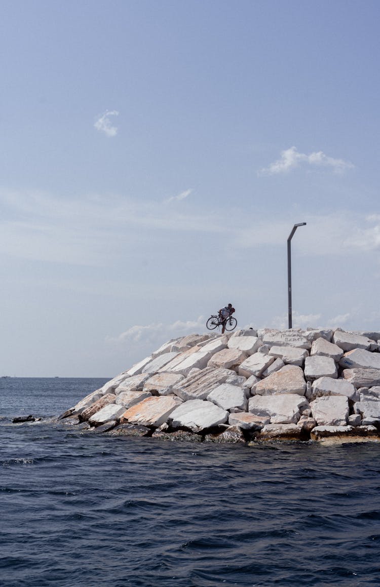 Person With A Bicycle On Stone Dock