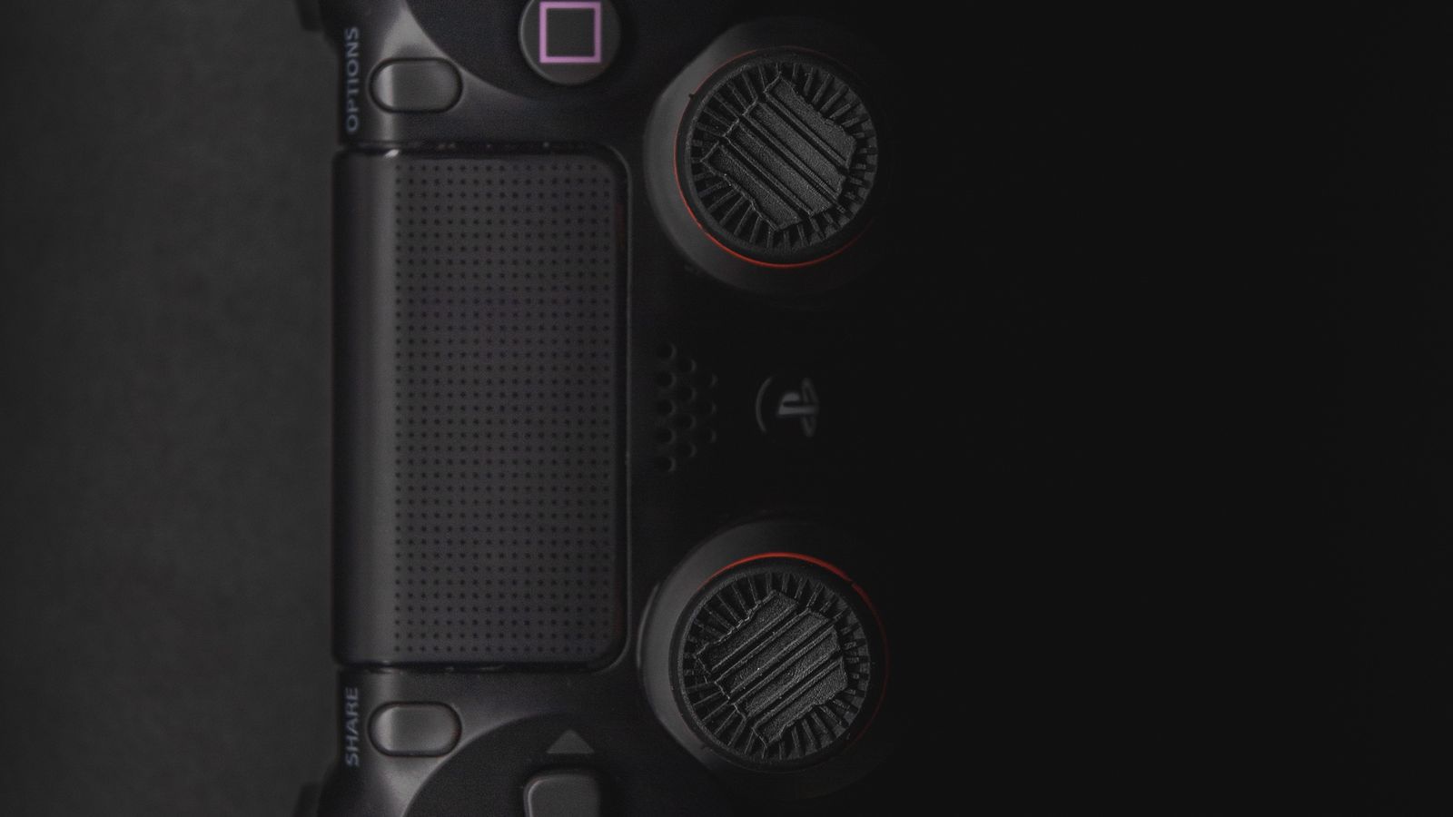 A game controller resting on a sofa in front of a television