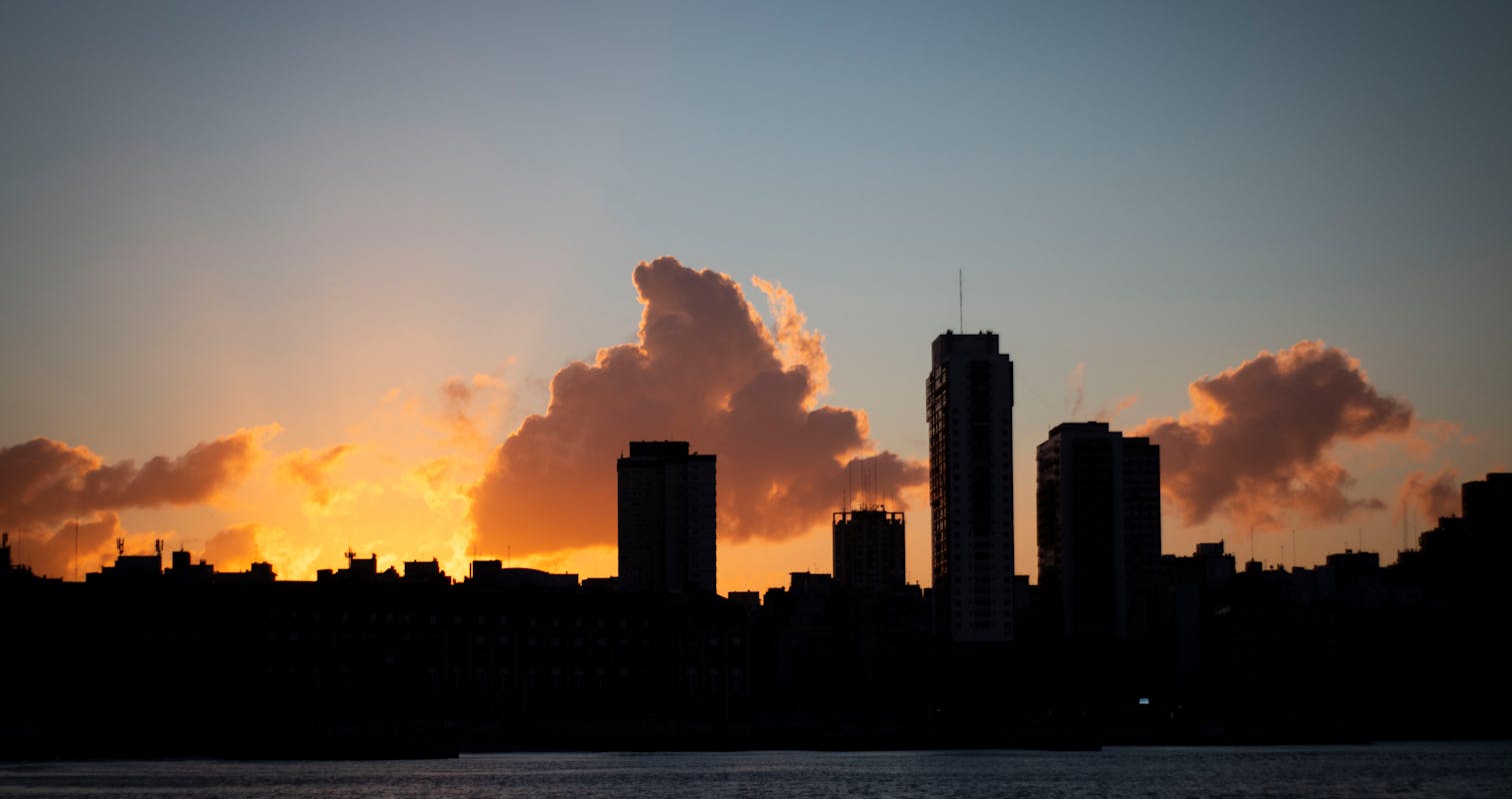 City Skyline Under Orange and Gray Cloudy Sky during Sunset in Rosario, Argentina.