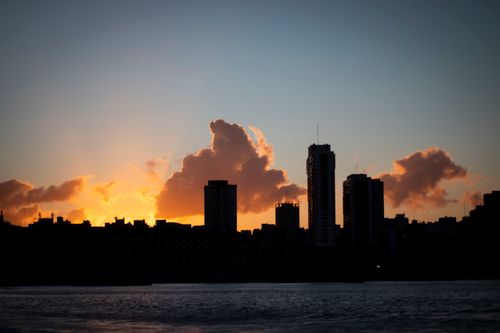 Free Captivating silhouette of Mar del Plata skyline during sunset, reflecting upon the Atlantic coast. Stock Photo