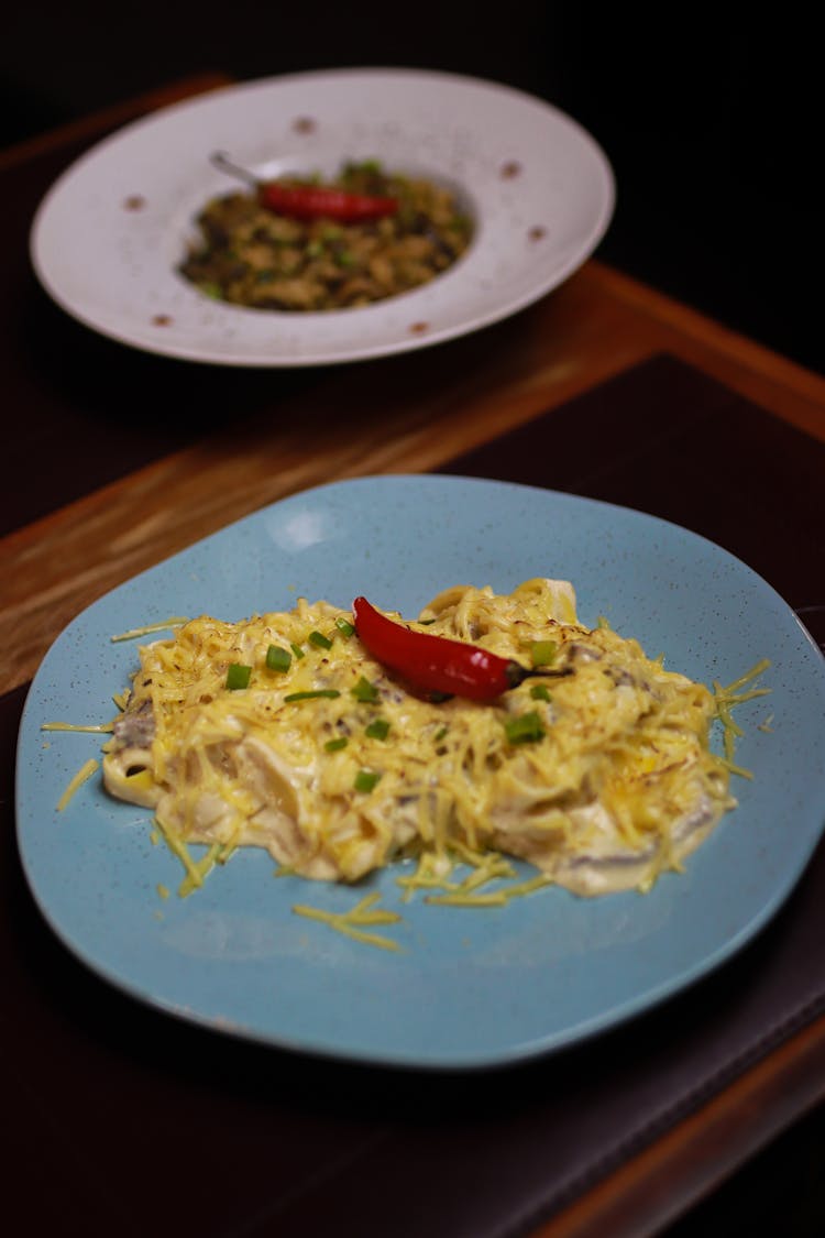 Cooked Food On Blue Ceramic Plate With Red Chili