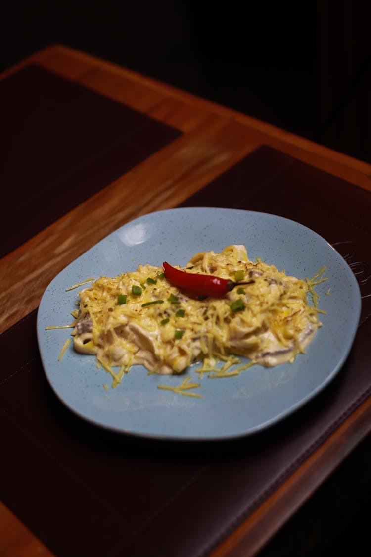 Plate With Pasta And Red Pepper On A Table