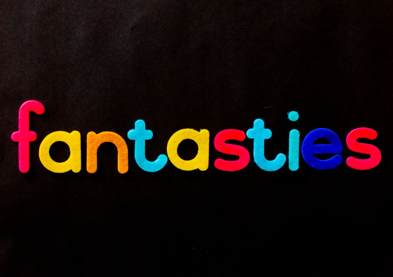 bright and colorful lettering spelling fantasies on a black background