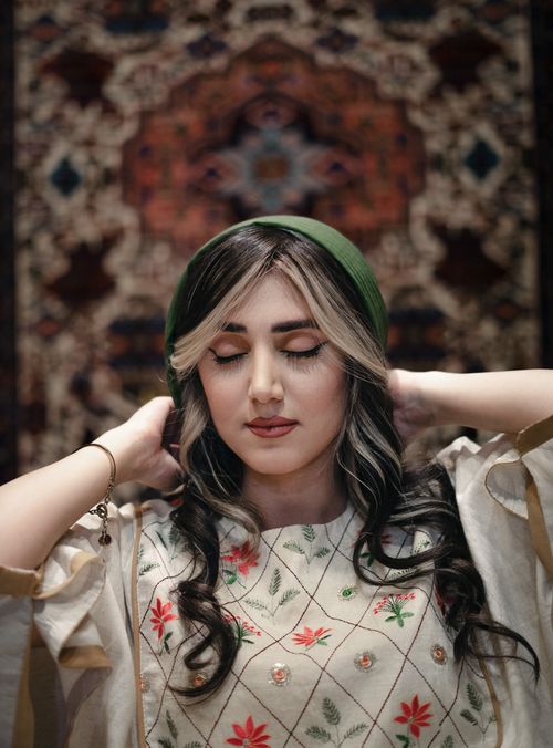 Free Elegant portrait of a woman in Ardabil, Iran with eyes closed and floral blouse. Stock Photo