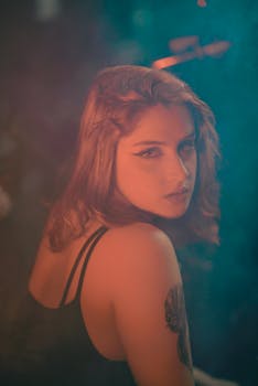 A dramatic portrait of a woman with artistic lighting creating a mysterious mood.