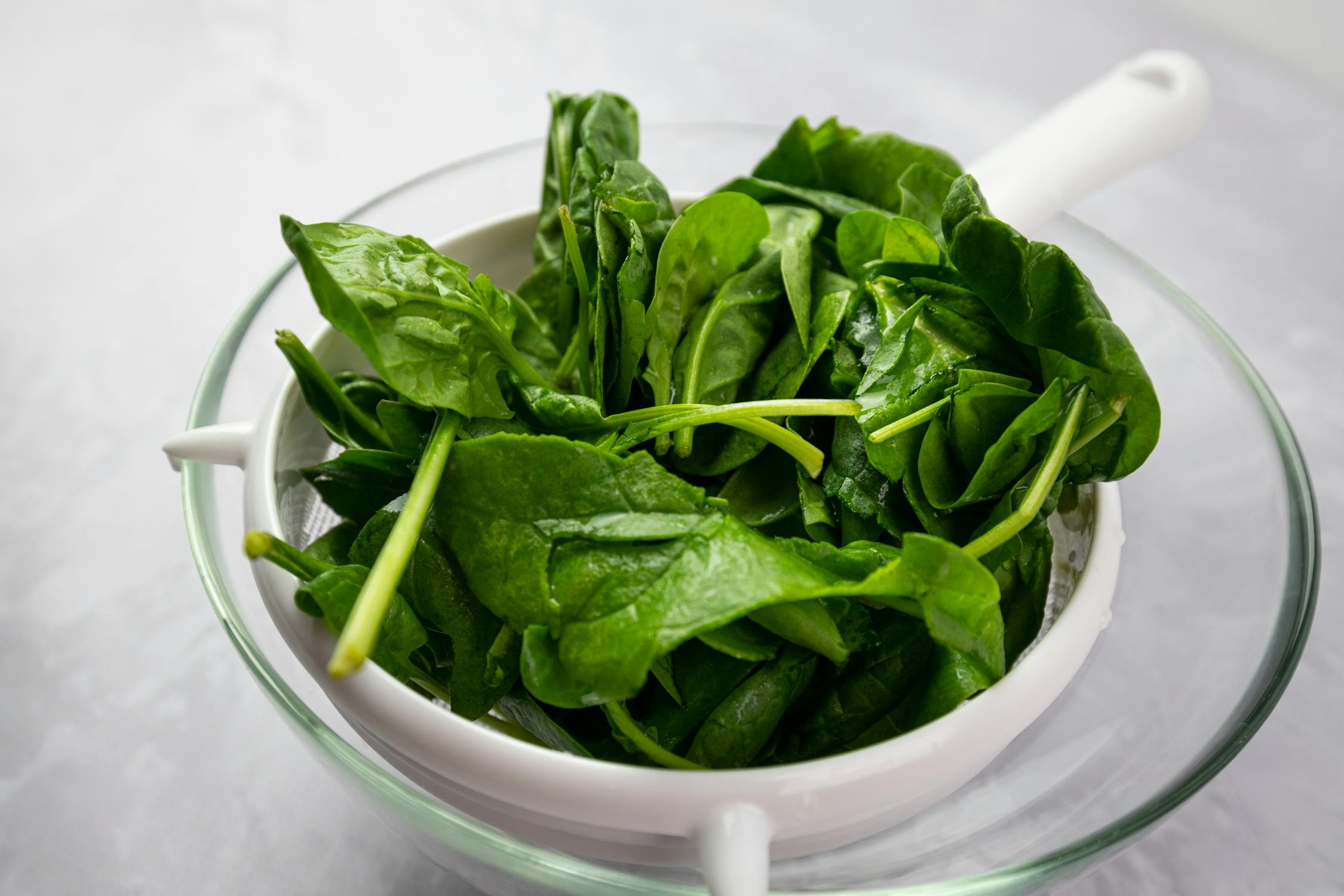 Fresh Spinach in White Strainer and Glass Bowl · Free Stock Photo