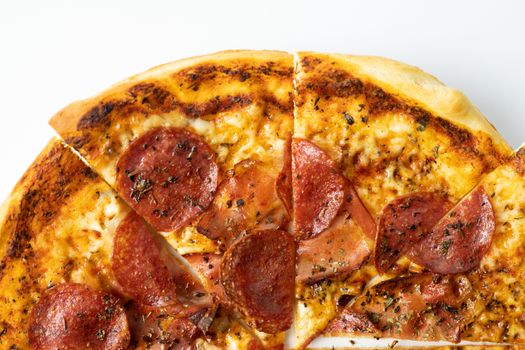 Delicious pepperoni pizza with melted cheese and herbs, sliced and ready to eat.