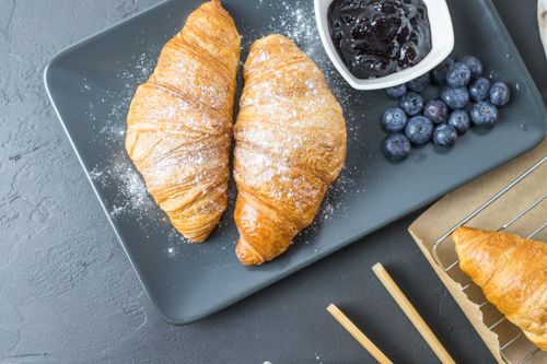 Free Top view of croissants with blueberry jam and a side of fresh blueberries. Stock Photo