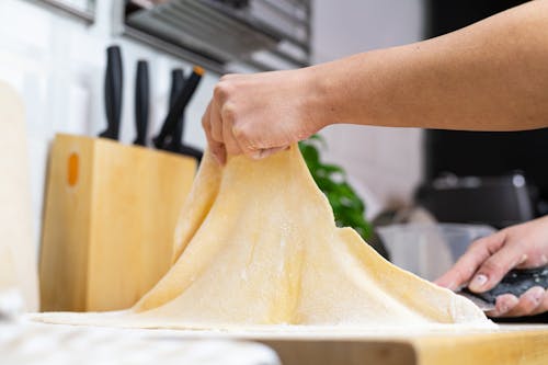 Woman Preparing Dough in a Kitchen