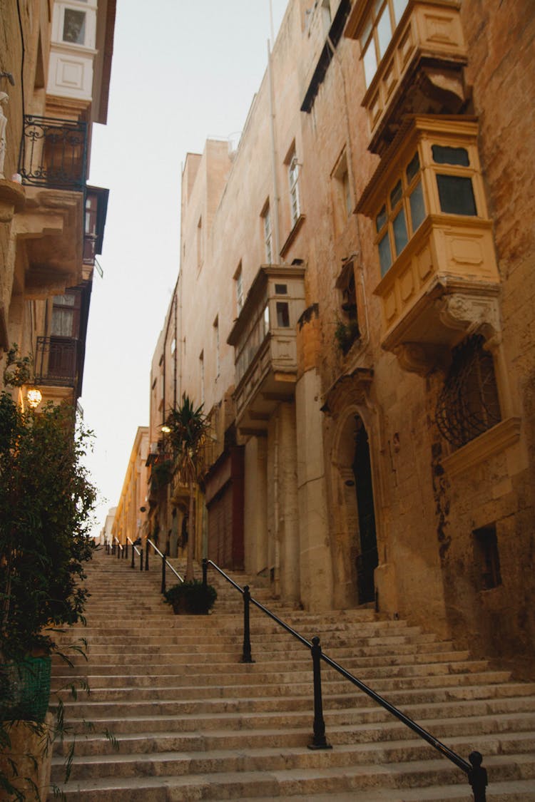 Brown Concrete Buildings With Stairs