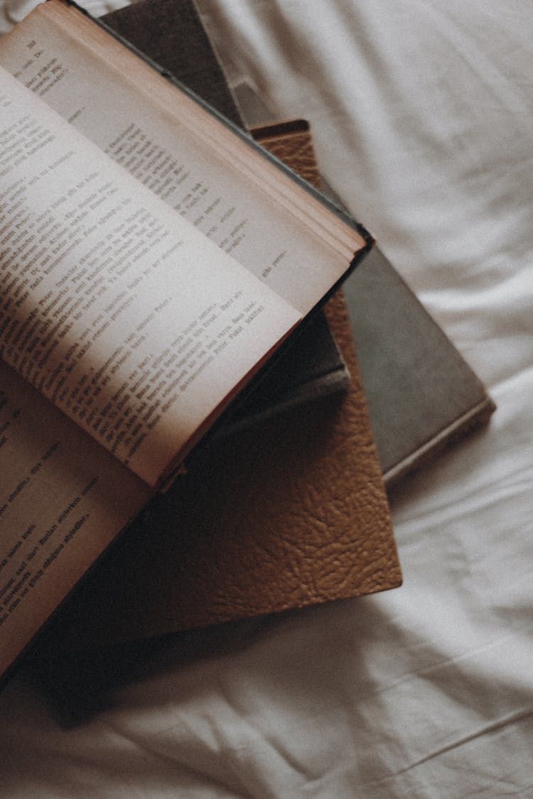 Stacks Of Books On A White Surface