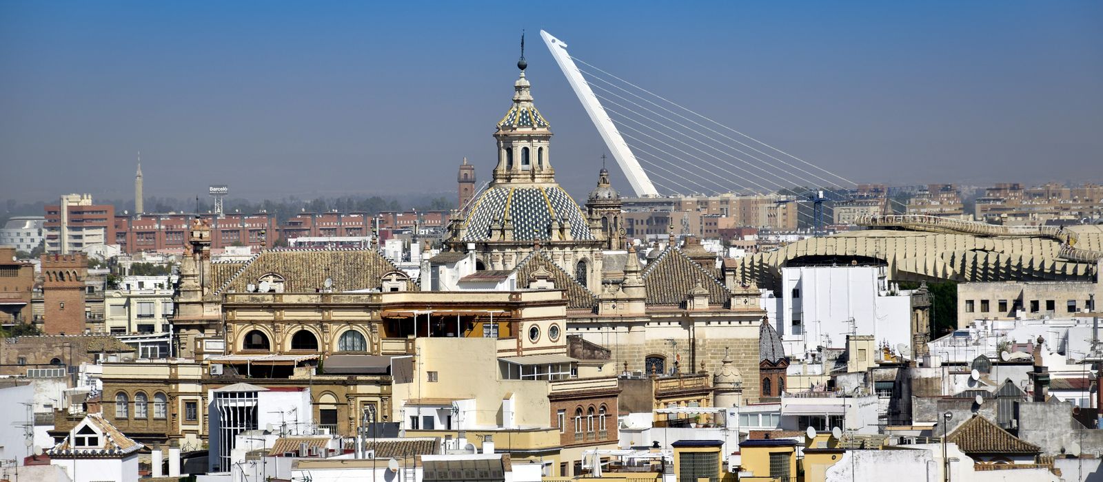 Elevated view of Sevilla's skyline showcasing historic architecture and the Puente del Alamillo.