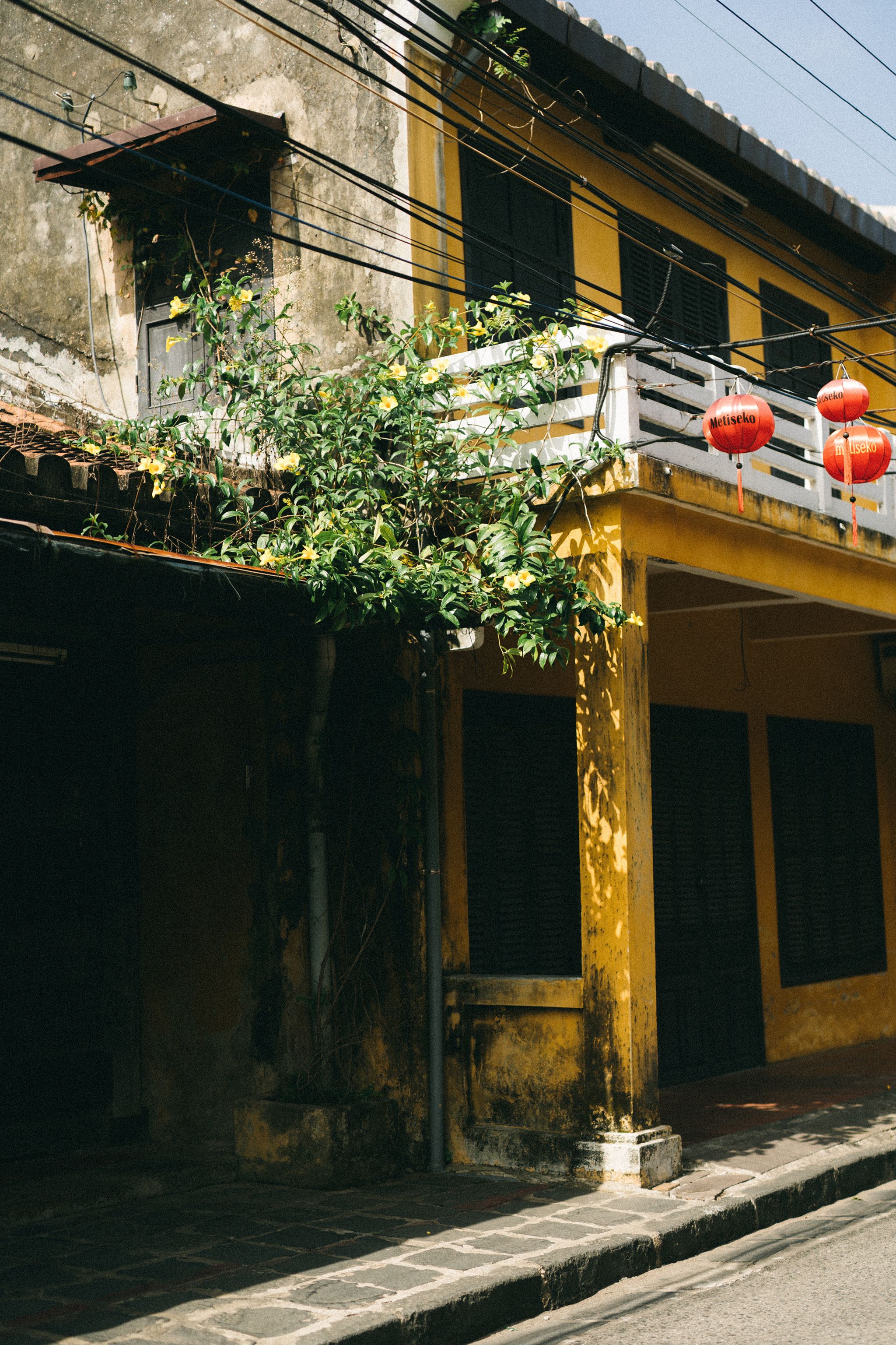 Vintage architecture with lanterns in Hội An, Vietnam, capturing historic charm.
