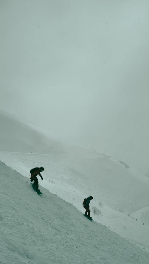 People Snowboarding on Mountains