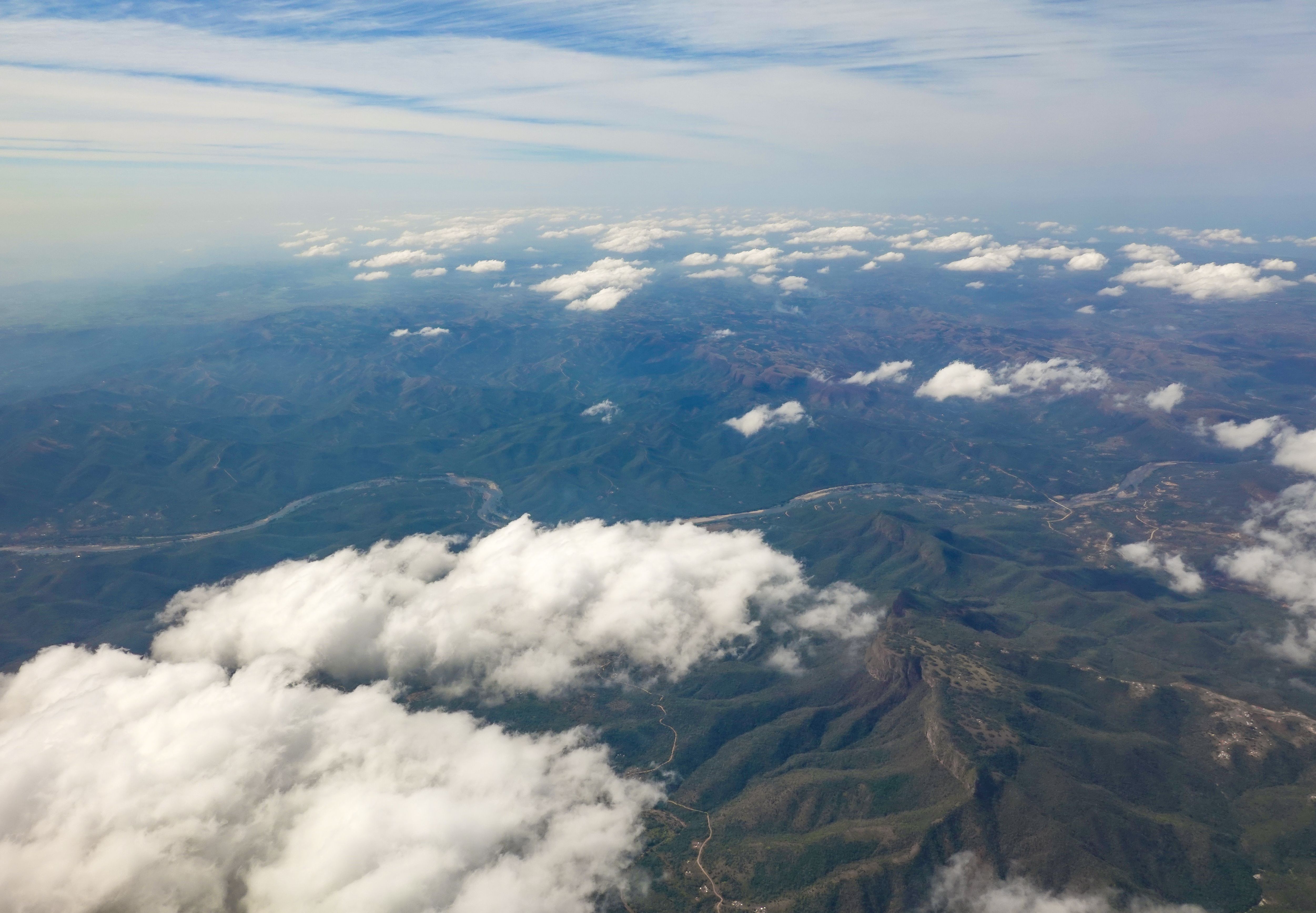 Aerial View of Green Mountains Under White Clouds · Free Stock Photo