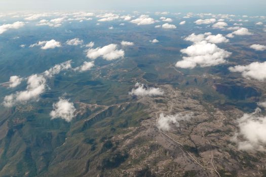 Stunning aerial view of KwaZulu, South Africa, showcasing vast landforms beneath scattered clouds.