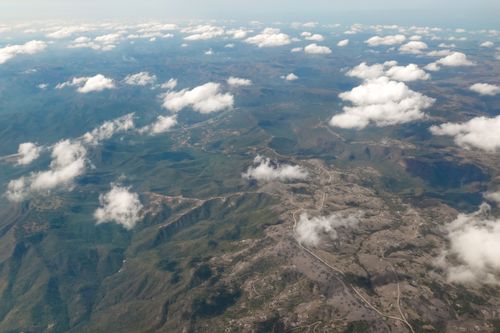 Free Stunning aerial view of KwaZulu, South Africa, showcasing vast landforms beneath scattered clouds. Stock Photo