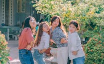 Four Women Standing Near Plants Taken