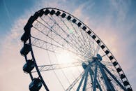White Ferris Wheel Under Cloudy Sky