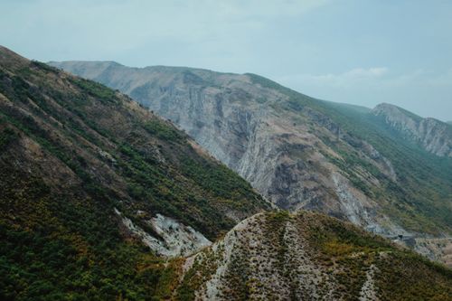 Free A breathtaking view of rugged mountains, showcasing diverse terrain and natural beauty under a clear sky. Stock Photo